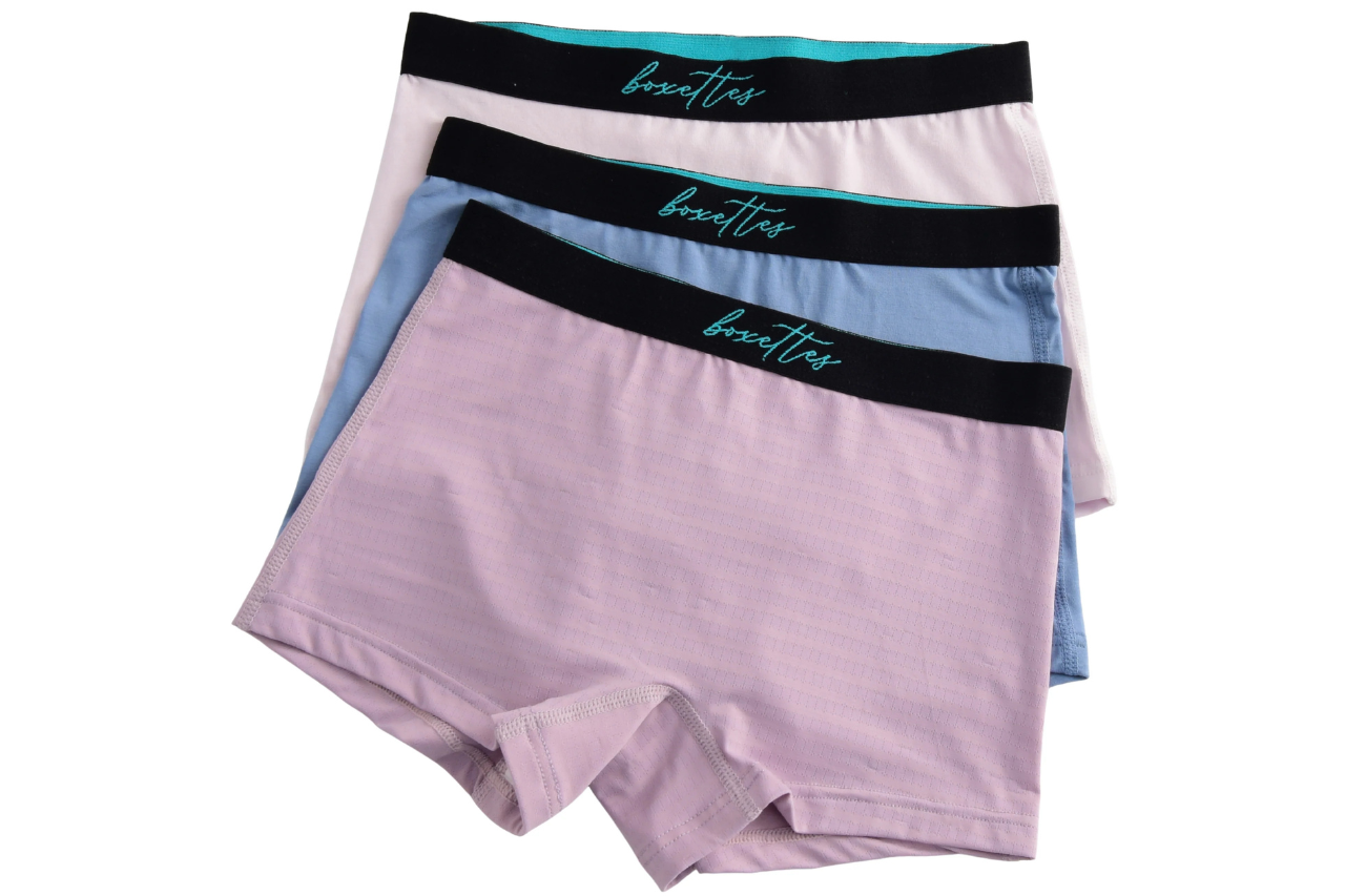 Three pairs of boxer briefs with black bands featuring the brand name on a white background.