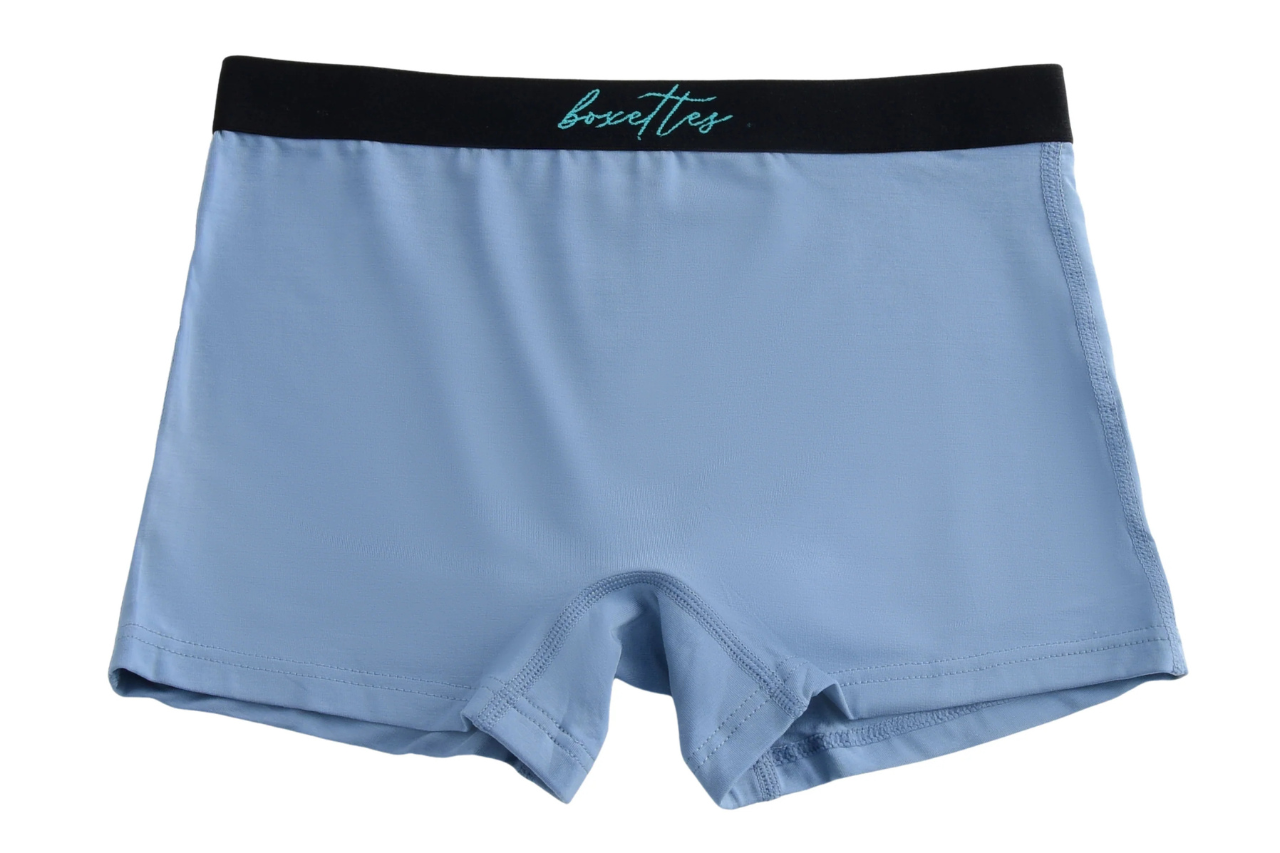 Light blue boxer briefs with black waistband on a white background