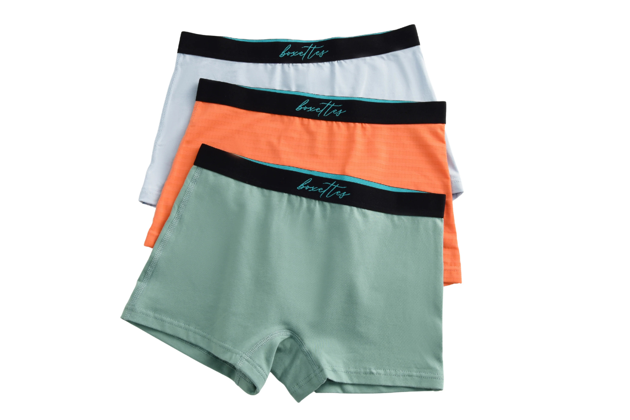 Three pairs of men's underwear with different colored waistbands on a white background.