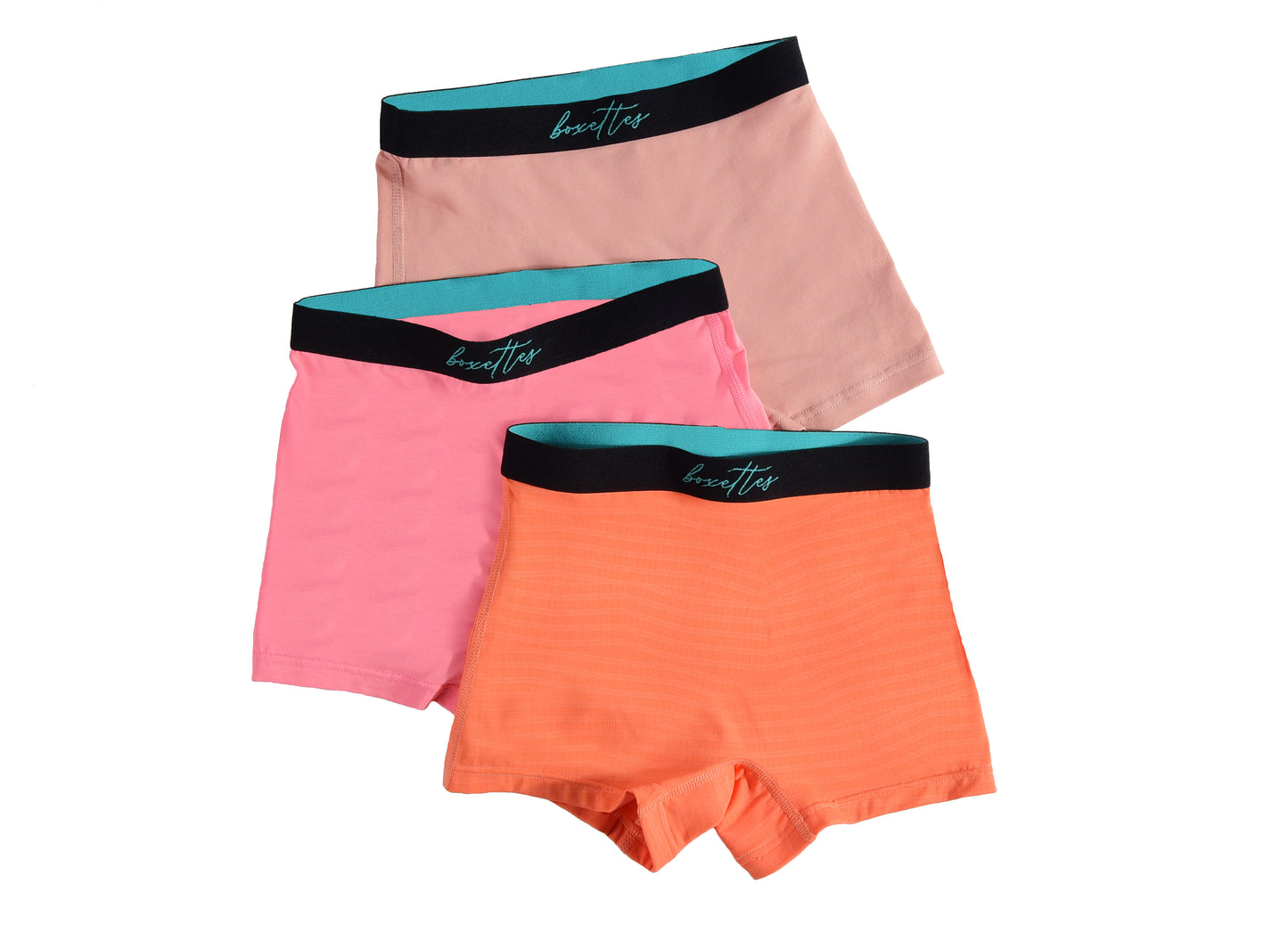 Three girls boxer briefs in pink orange and peach showing mixed fabrics from Boxettes