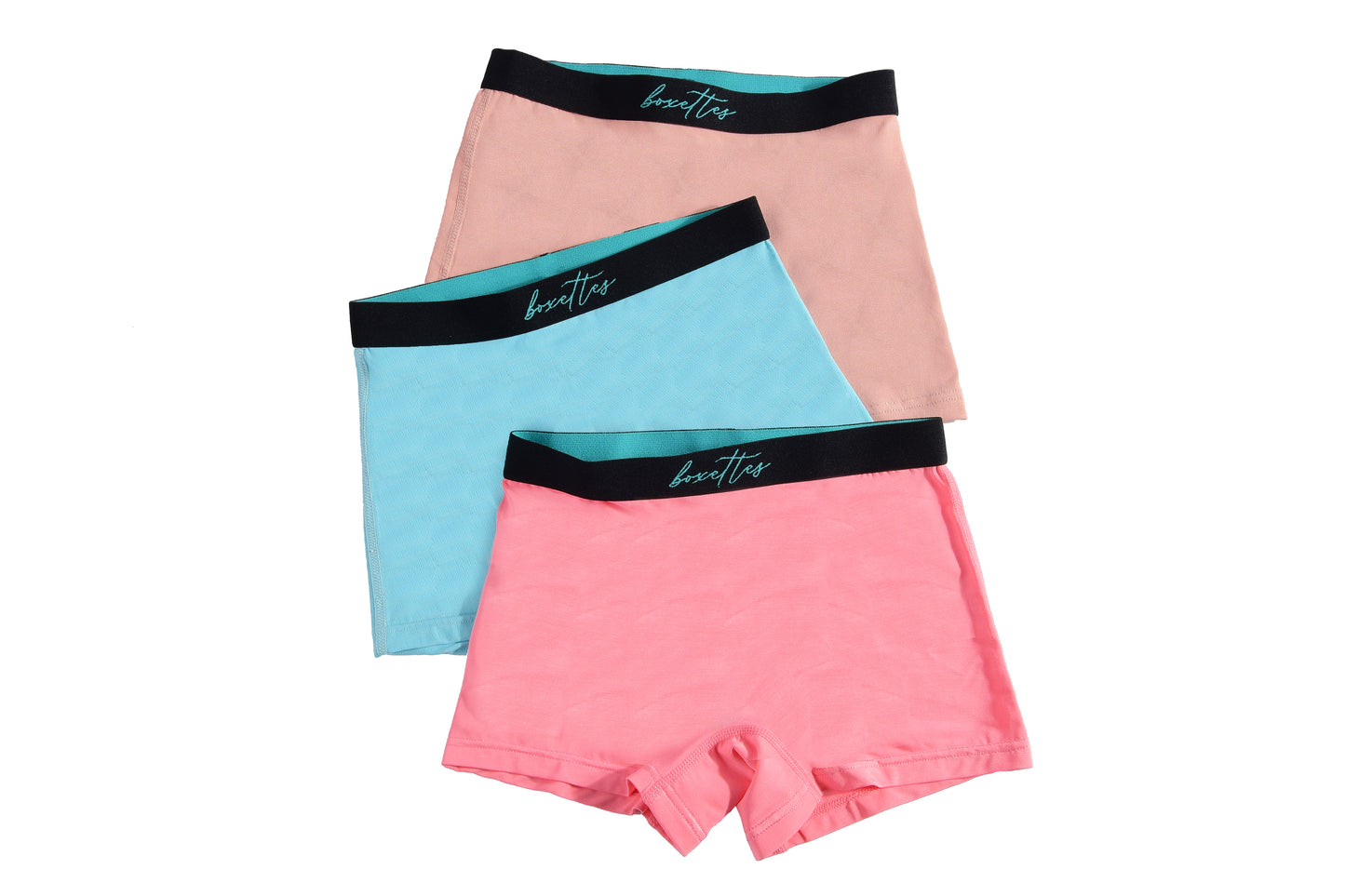 Three girls boxer briefs in pink blue and peach showing breathable soft material from Boxettes