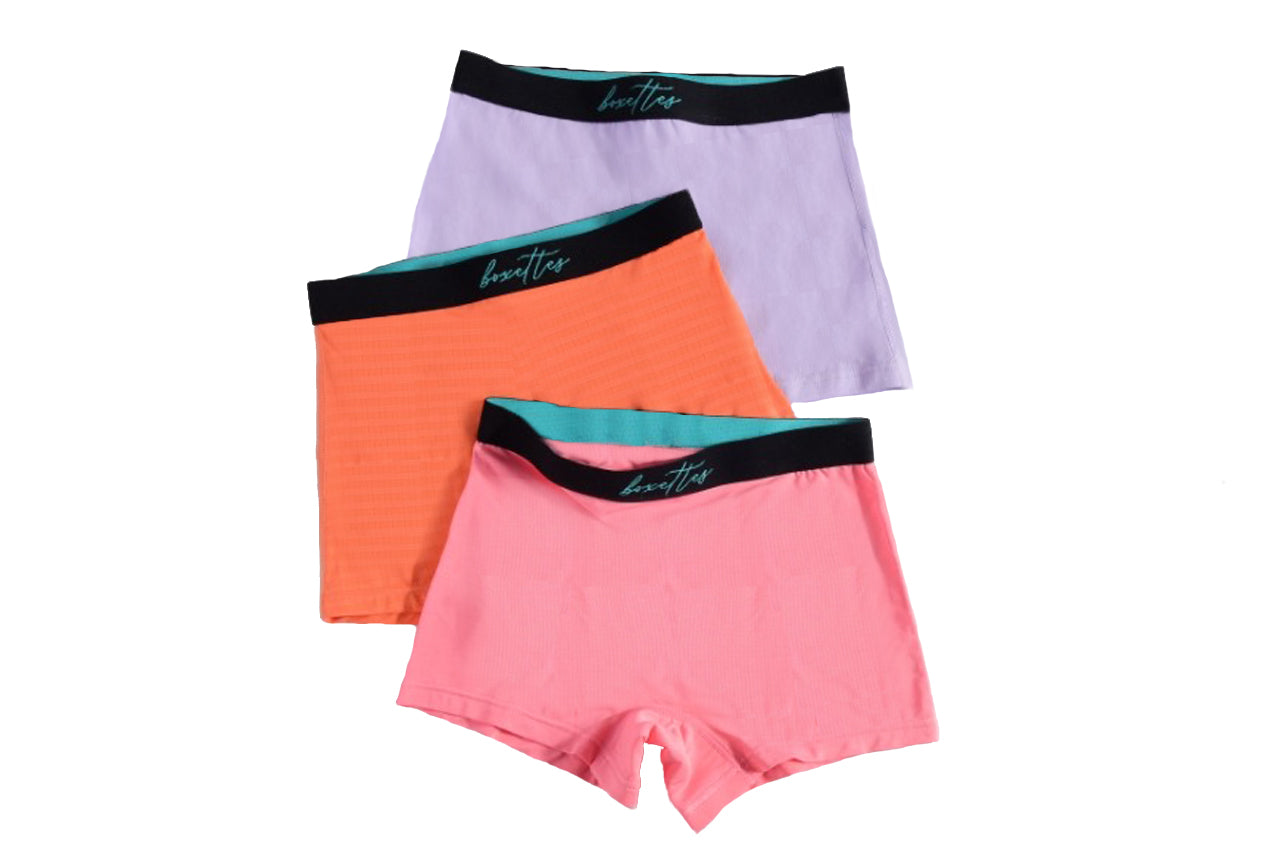 Three girls boxer briefs in purple orange and pink arranged in a breathable mesh style