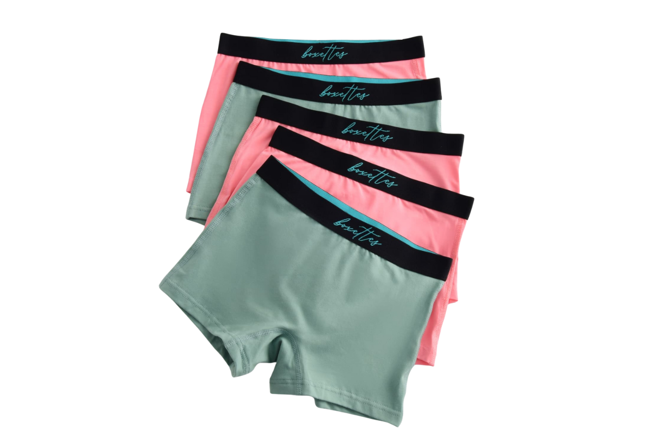 Four pairs of women's underwear with black waistbands on a white background