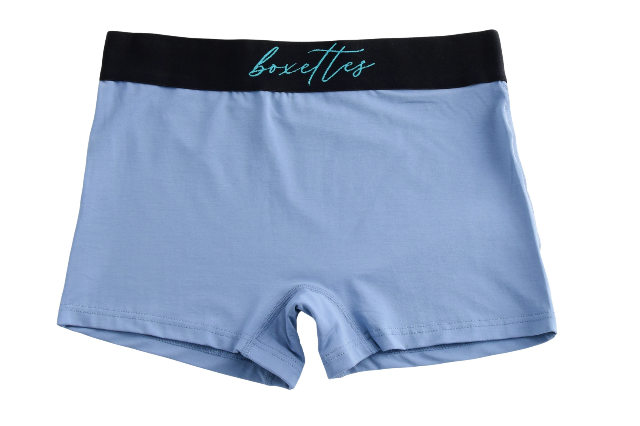 Light blue boxer briefs with black waistband and 'boxettes' branding on a white background