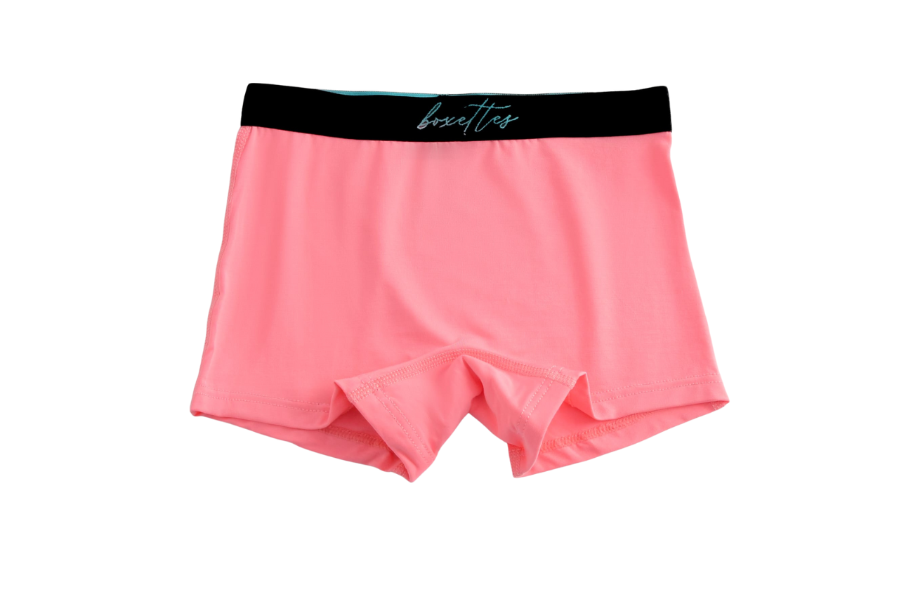 Pink boxer briefs with a black waistband on a white background
