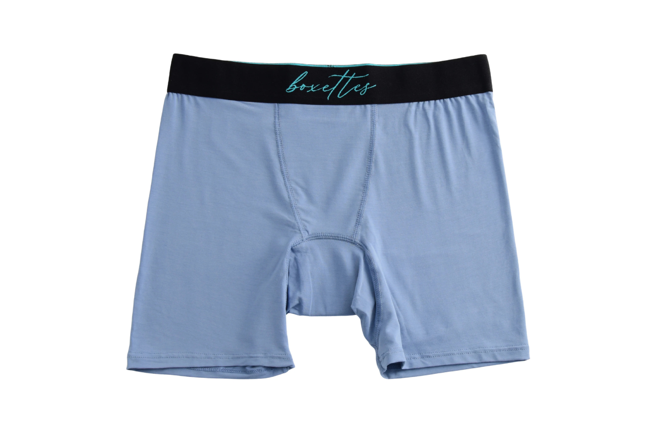 Light blue boxer briefs with black waistband on a white background